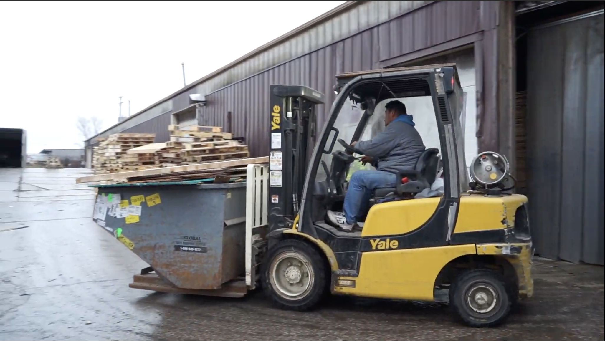 forklift carrying scrap wood