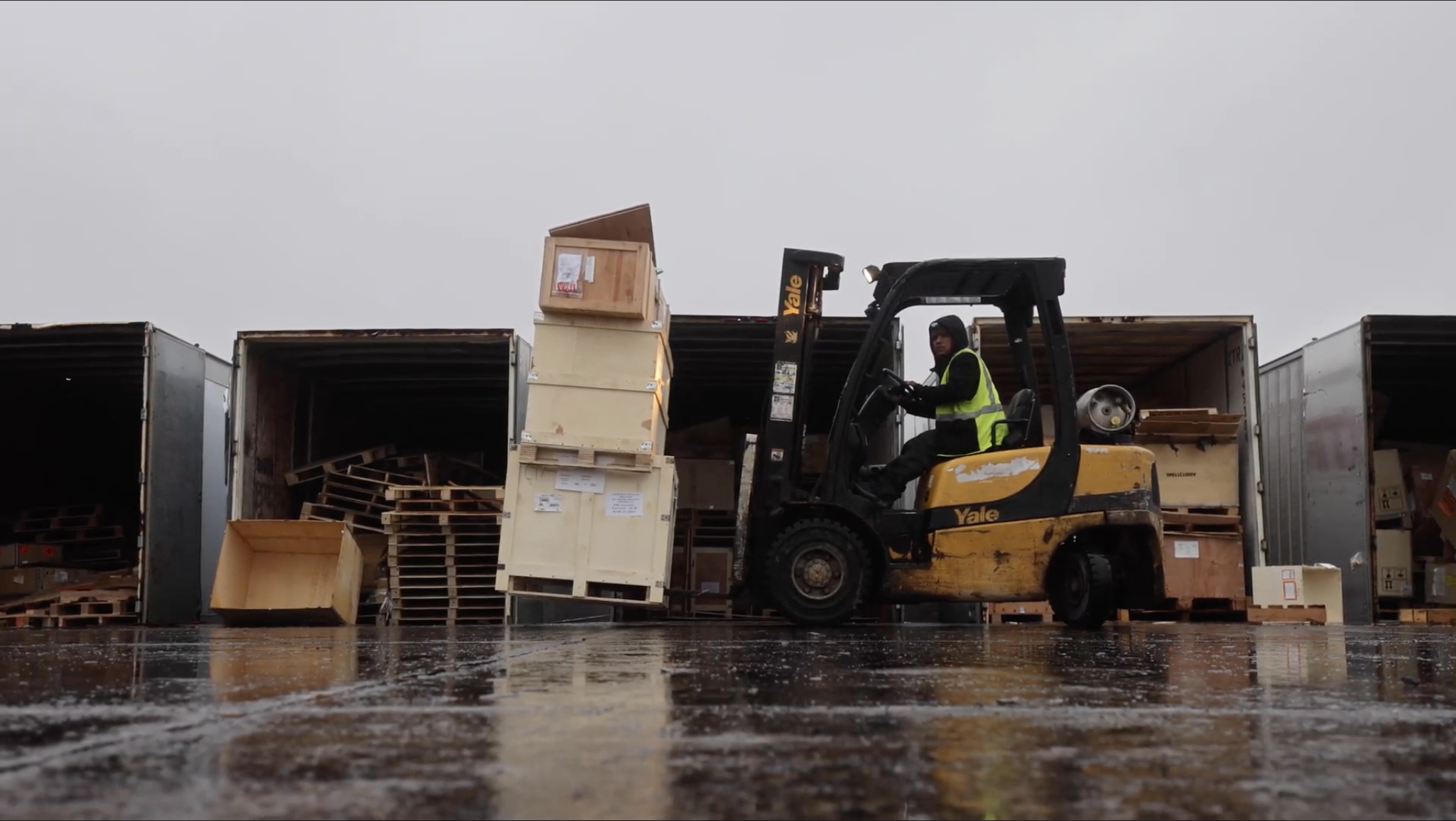 skid loader moving scrap pallets, part of BTL's wood waste diversion operations